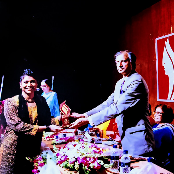 Dr Nusrat Mumtaz Ruposhi receiving an award
